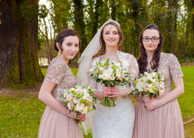 Bride and bridesmaids laughing during hair and makeup in Nottinghamshire