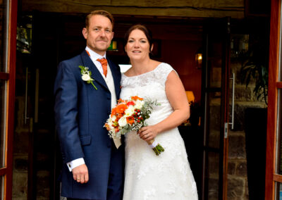 Bride and groom sharing a romantic stroll through a garden in Long Eaton